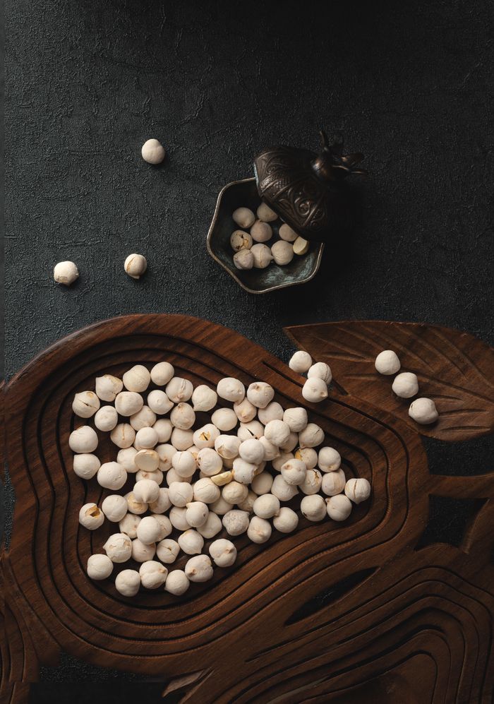 A flat lay of roasted chickpeas in a decorative wooden bowl, embodying Turkish cuisine.